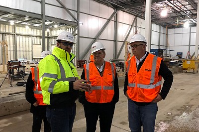 A crew discusses the plans for the Hager plant